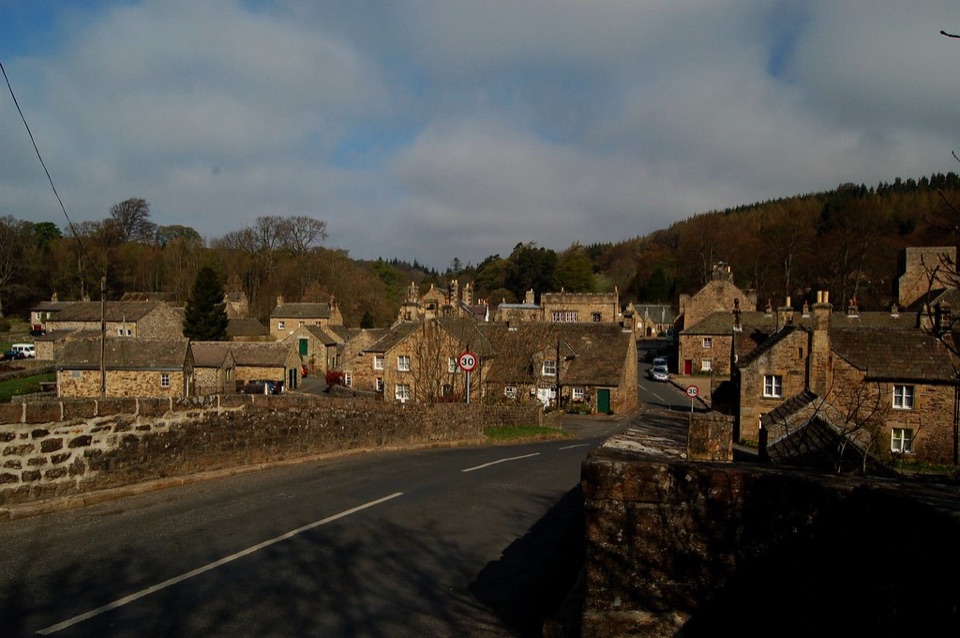 Stone houses lining a hillside road through a village in the North East