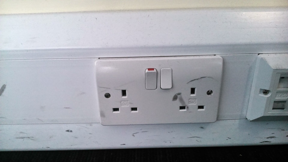 A white switched double 13 amp socket outlet mounted in surface trunking